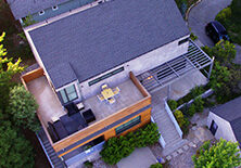 Aerial view of house with shingled roof